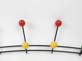 a coat rack that has a bunch of colorful balls on it