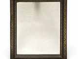 a close up of a mirror on a white surface with a white background