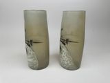 two tall glass vases that have a picture of a lighthouse on them