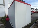 an image of a portable toilet in a parking lot