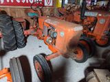 a tractor and a tractor plow in a garage