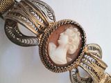 a picture of a bracelet with a lady ' s face on it