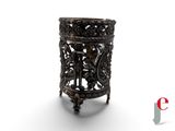 an image of a small metal vase with a design on it