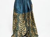 a mannequin dress with a blue and gold skirt on a mannequin mannequin
