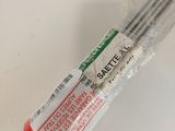 someone is holding a pair of chopsticks that are wrapped in plastic
