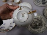 a person holding a tea pot in their hand