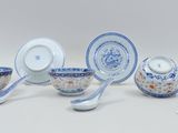 a group of blue and white dishes and spoons on a table
