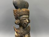 a close up of a statue of a person with a hat on a stick