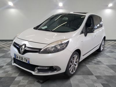 a picture of a white car that is parked in a garage