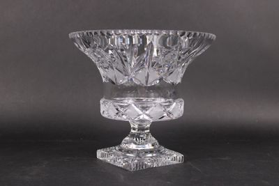 a clear glass vase on a table with a black background
