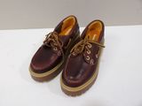 pair of brown leather shoes with brown laces on a white surface