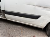 a white van that is parked on the side of the road
