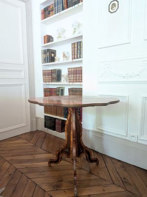 a small table with a wooden top in a room