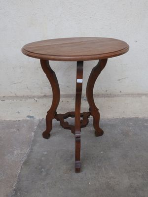 a small table with a wooden top on a concrete floor