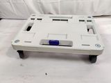 a white tray that has a blue button on it