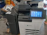 a multi - function printer sitting on a pallet in a warehouse