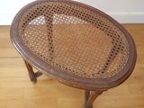 an image of a wooden table with a wicker top on a hard wood floor
