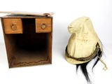 a hat sitting on top of a wooden table next to a small desk