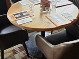 tables and chairs in a restaurant with a view of the street