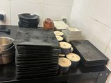 a black counter top with pots and pans on it