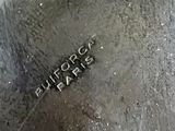 a close up of a metal object with a name on it