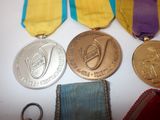 three medals and a keychain on a table