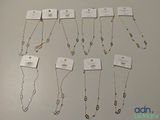 a lot of necklaces that are on display on the table