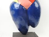 a colorful sculpture of a woman on a black base