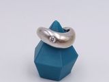 silver ring with a diamond on top of a blue cube