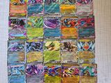 a pile of pokemon cards sitting on top of a table