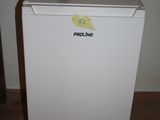 an image of a small white refrigerator in a room