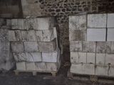 two white refrigerators stacked on pallets in a room