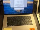 two laptops sitting on a desk with sticky notes on them