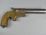 a close up of a gun on a table with a white background