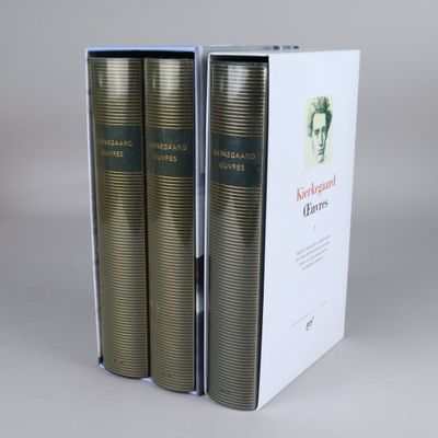 two books in a white box on a gray surface