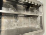 a stainless steel cabinet with a glass door in a kitchen