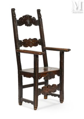 an old wooden chair with a carved back and seat