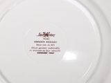 a white plate with a red and black design on it