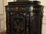 a black cabinet with a clock on top of it