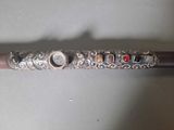a silver stick with a design on it that has stones on it