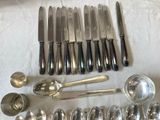 a lot of silver spoons and spoons on a table