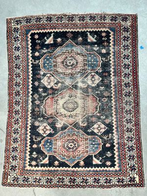 an antique rug with a blue and red design on it