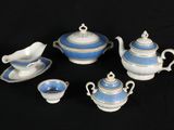five pieces of blue and white tea set on a black background