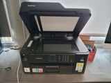 a printer sitting on top of a counter next to a window