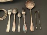 five spoons, a fork, and a spoon rest on a table