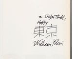 an open book with handwriting on it and a picture of a man in a suit