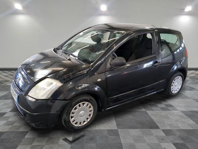 a picture of a small black car on a checkered floor