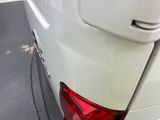 a close up of a white car with a red tail light