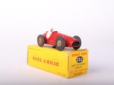 a red toy car sitting on top of a yellow box