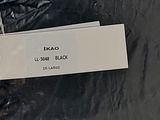 a black plastic bag with a white label on it